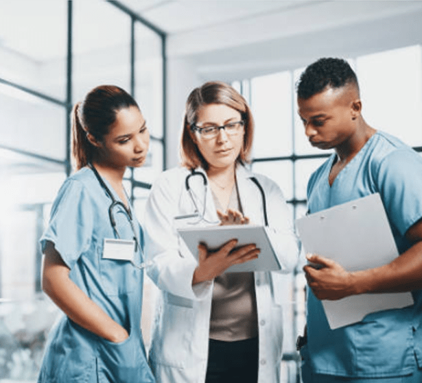 Doctors and nurses discussing chart.
