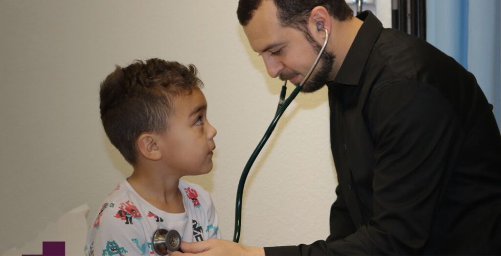 physician examining a little boy