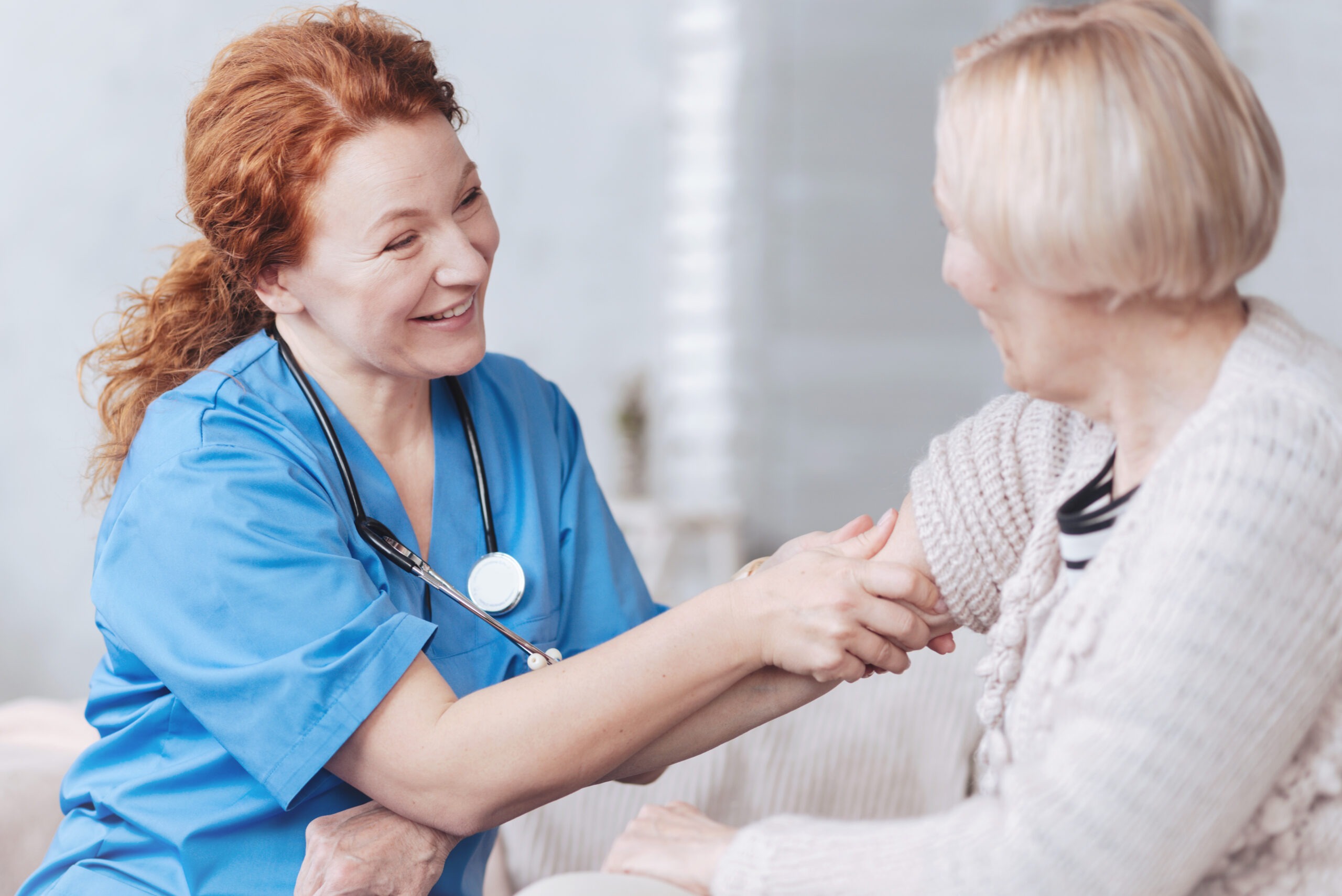 a doctor examining her patient's arm