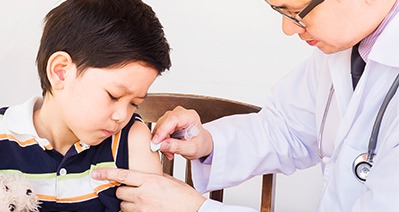 doctor giving a kid a vaccine