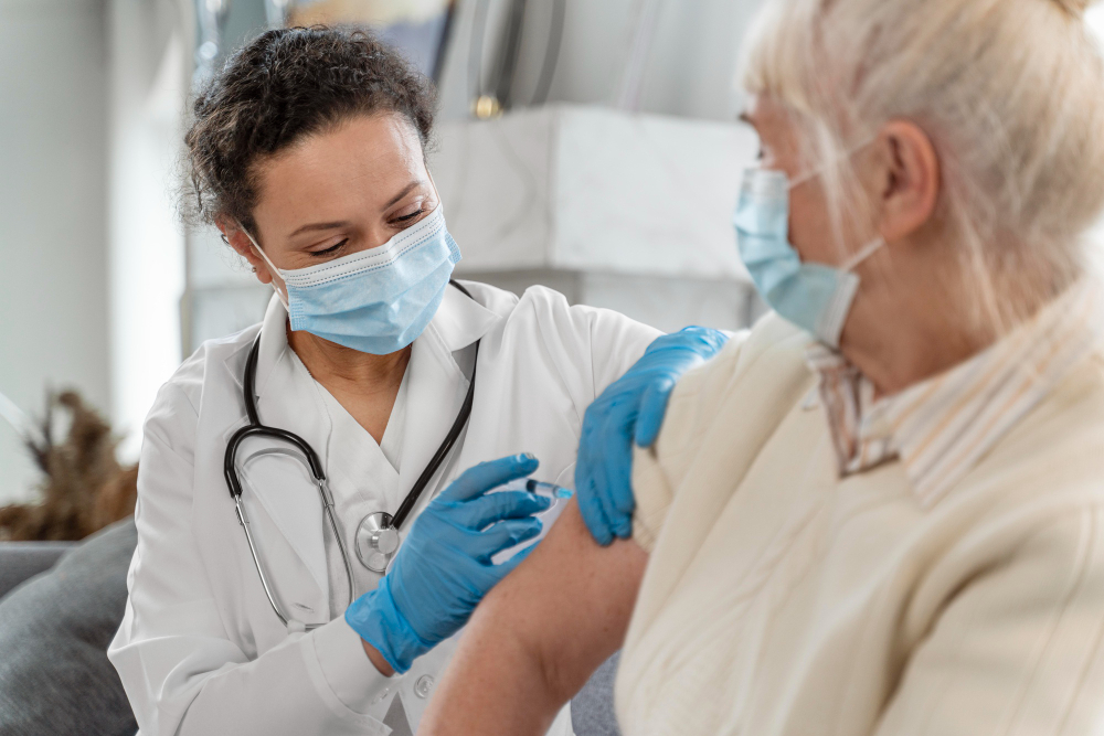 doctor vaccinating senior woman