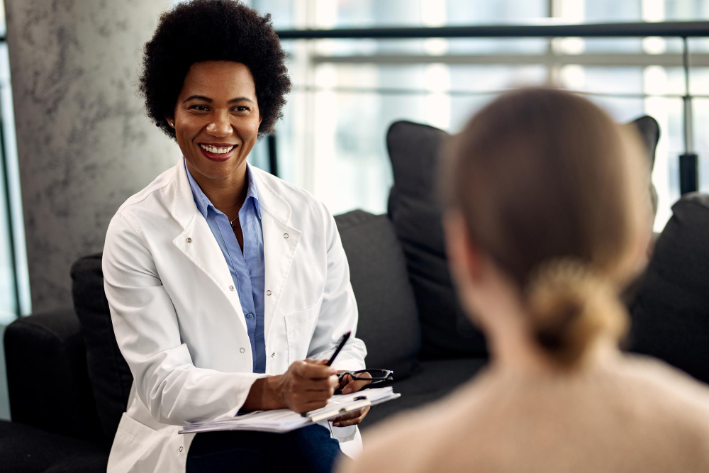 happy african american-doctor talking with female patient during psychotherapy session