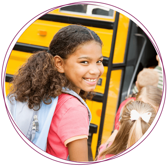 a litle girl going to her school bus