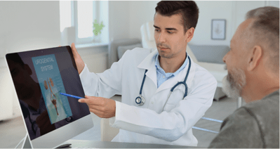 medical doctor showing a screen monitor to his patient