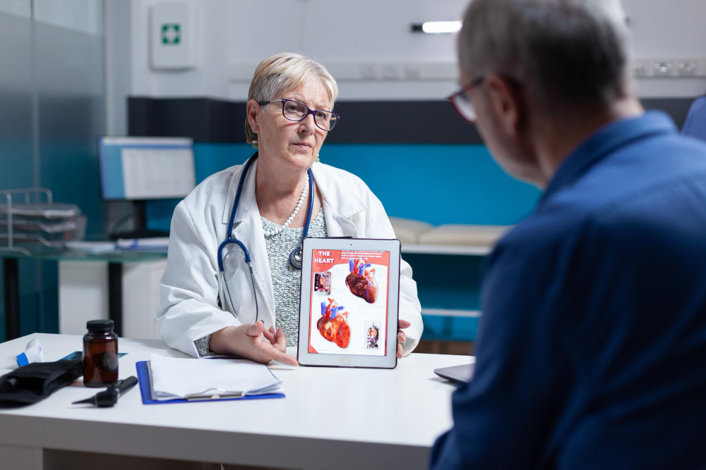Doctor showing a man a heart diagram