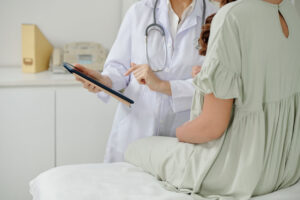 OBGYN is presenting family planning information to patient from tablet.